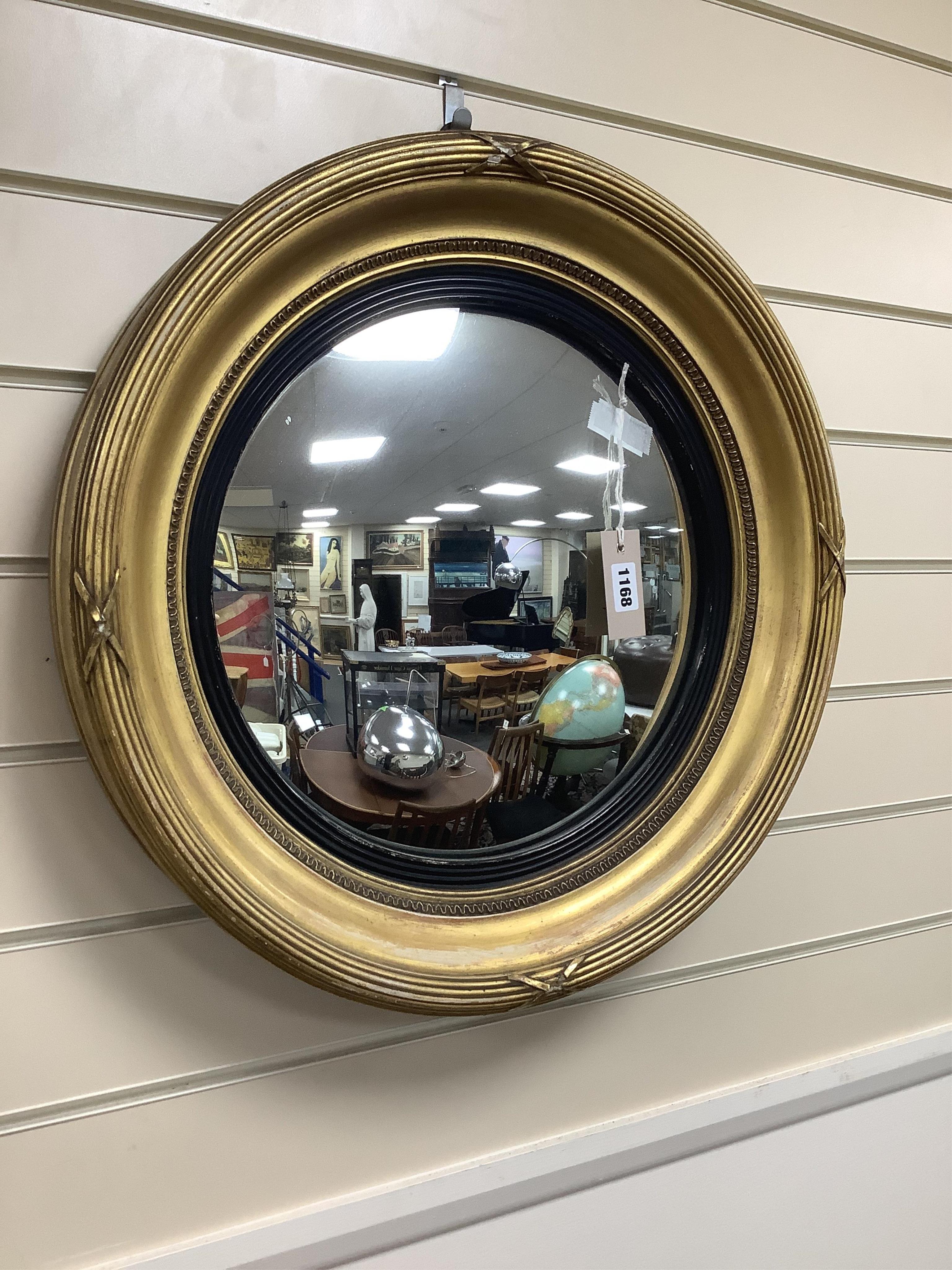 A Regency style circular gilt framed convex wall mirror, diameter 51cm. Condition - fair